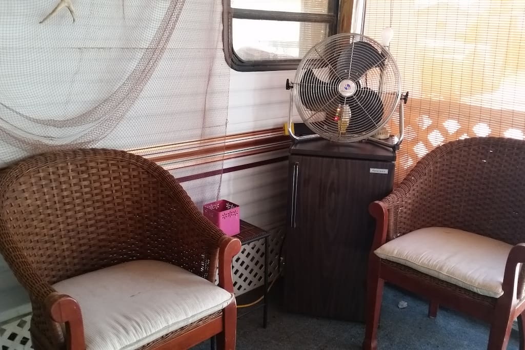 Seating area with mini fridge on screened-in porch