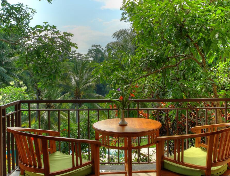 Balcony with view onto a lush forest