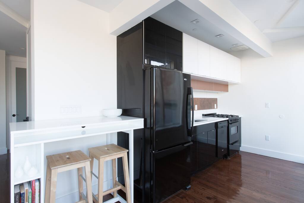 Minimalist's Designer Kitchen with custom lighting & three-door access to the main private terrace.