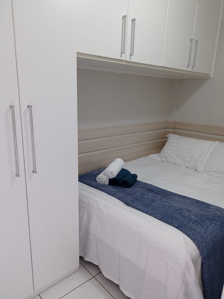 Bedroom with closets and double bed.