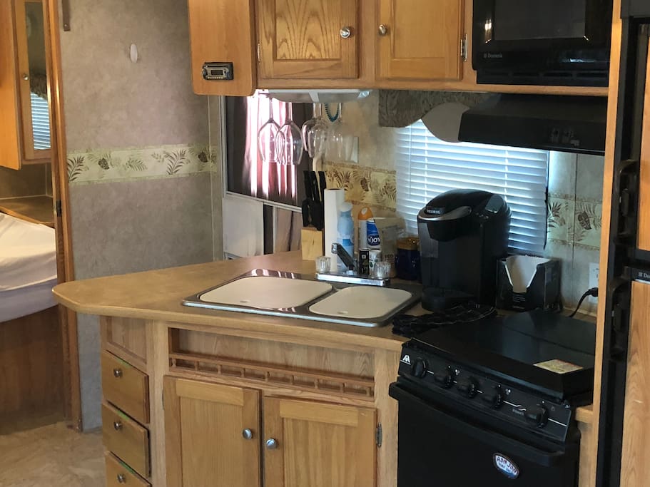 Nice big kitchen with a Keurig coffee maker, 4 burner gas stove top, oven & refrigerator / freezer.