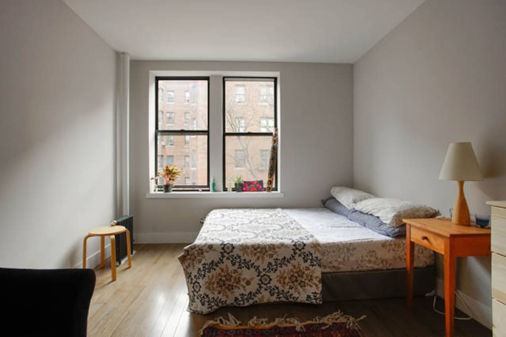 Your room. It's big, warm and cozy and feels like a sanctuary. Candles and natural light. The rugs are from Afghanistan. Wooden decorations from Ethiopia. Futon available for guests. Bedding from Morocco
