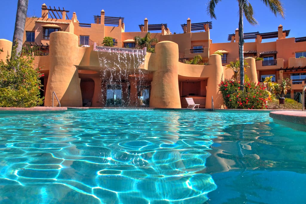 Great lagoon swimming pool with waterfall and pool house