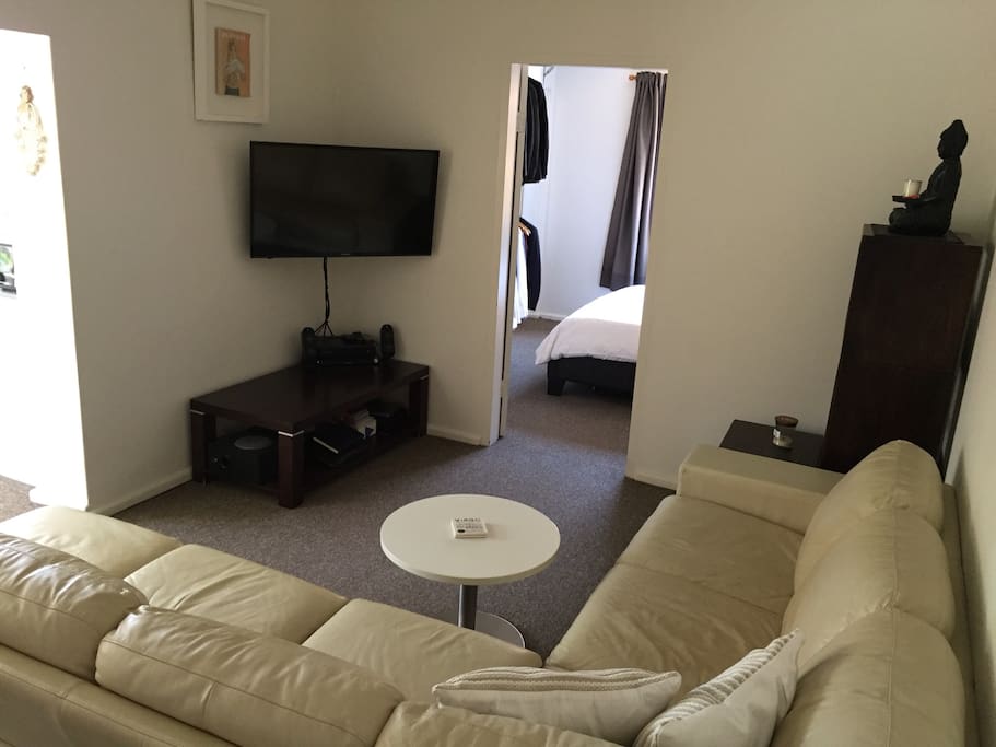 Big open living room space with FOXTEL television/ DVD player.