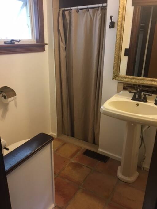 Private bathroom with newly restored sink, toilet, fixtures and shower