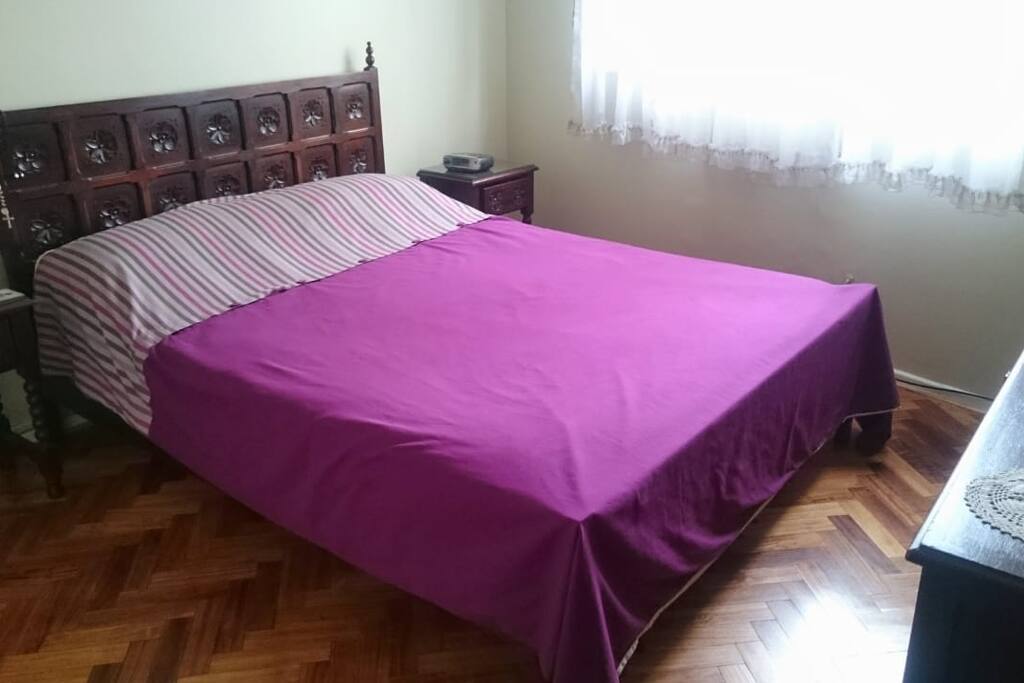 Master room with a queen bed and smart tv