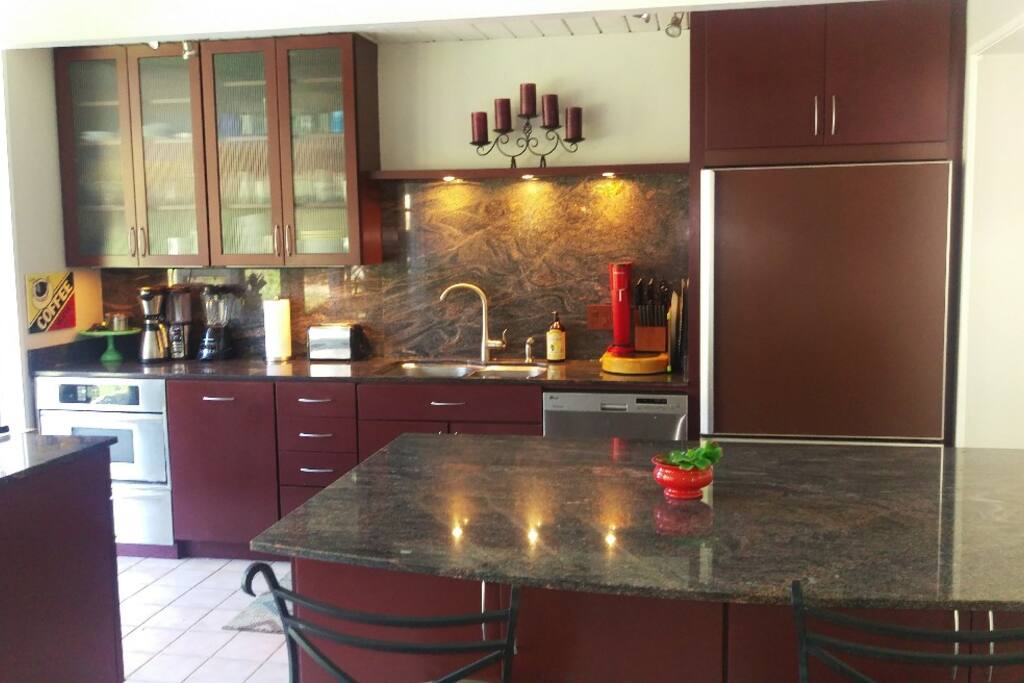 luxury kitchen with granite breakfast bar, stainless appliances, wolf stove with built in grill