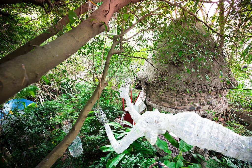 Tree House enshrouded in dreamy garden and work of arts
