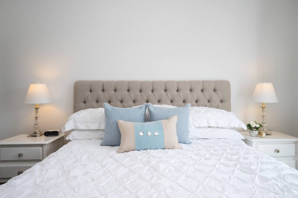 The master bedroom has a luxurious king size bed and ample space surrounding it