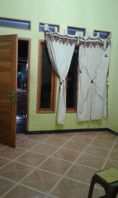 The living room, one room is have bigger space, you can asked for extra bed (with extra charge) in the living room if needed.