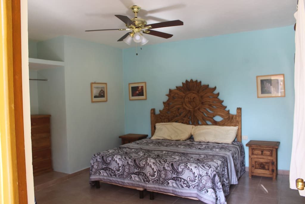 King size bed with hand carved headboard and night stands.