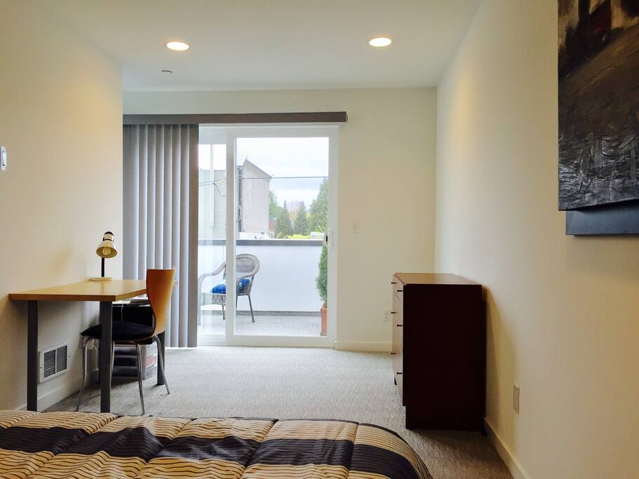 A dresser, a desk and private balcony
