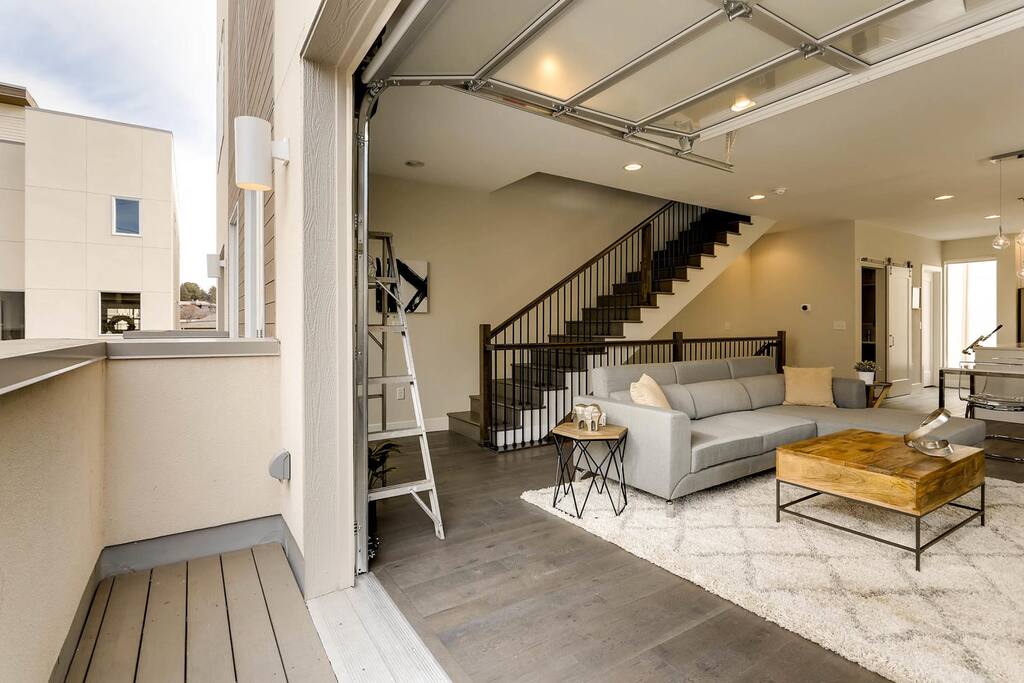 Large garage door opens onto main floor patio from living room