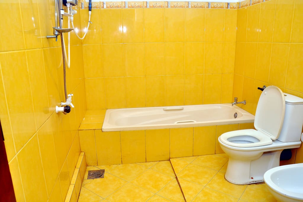 clean attached bath room with hot and cold water