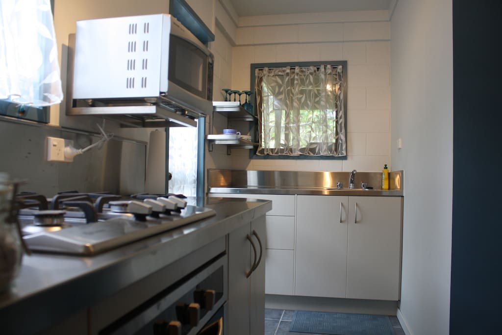 Kitchen with gas stove. There is a fireplace in here also