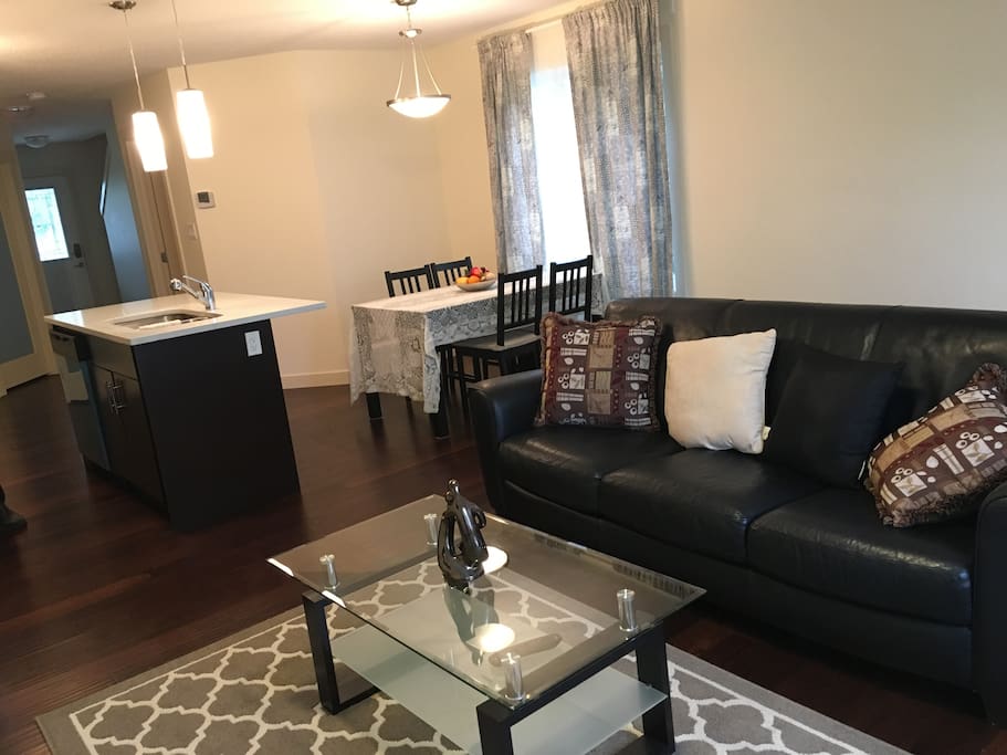 Living room with cozy leather couch and pillows to relax and enjoy watching your smart TV.