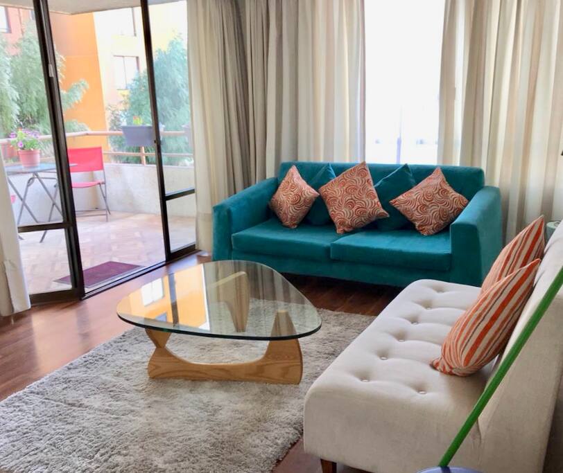 Open floor plan living room that opens to a terrace with a full view of the Andes Mountains.