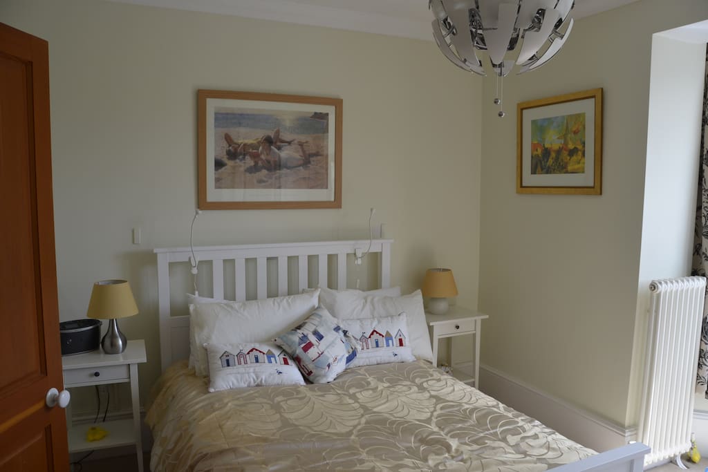 A bright double room with linen and towels