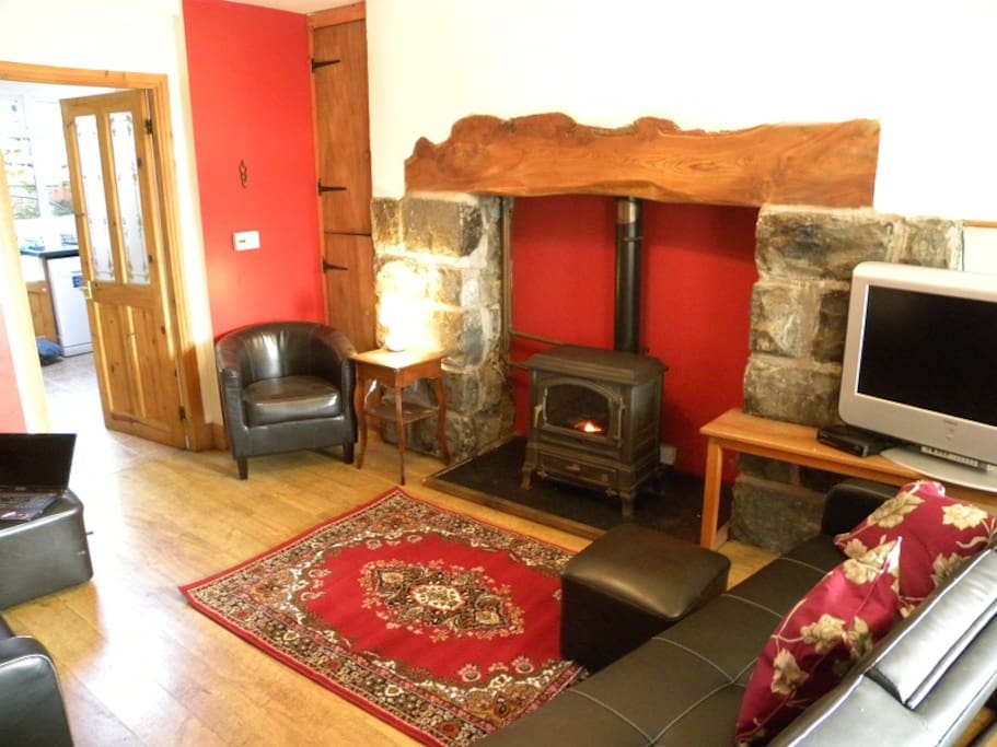 Lounge with inglenook fireplace and oil burner