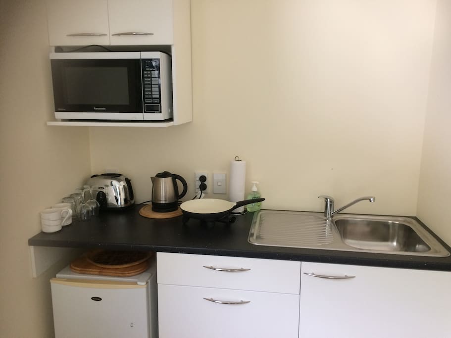 Kitchenette including fridge, toaster, electric jug, electric frypan, microwave. Wine glasses, cutlery and crockery for two persons,