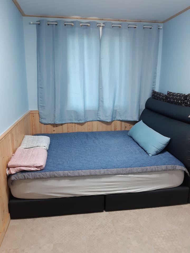Cozy bedroom with blackout curtains on a luxury bed