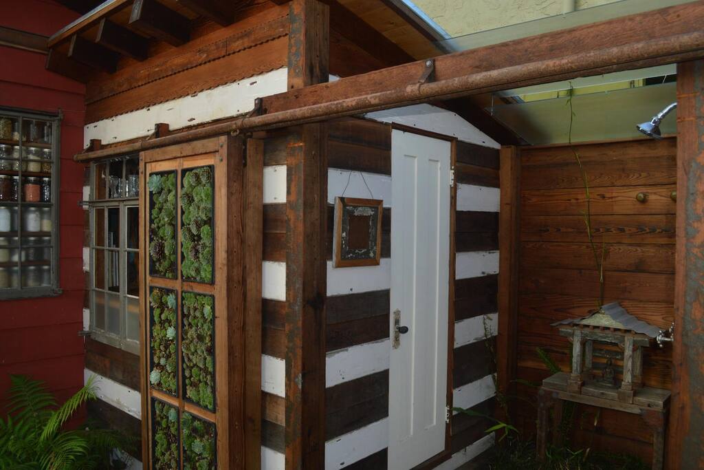 view of the outdoor shower with living wall slid open
