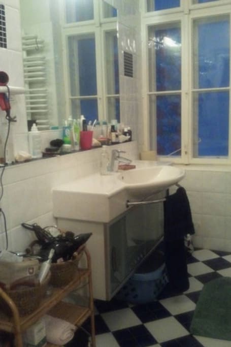 we share a modern spacious bathroom with bathtub and shower