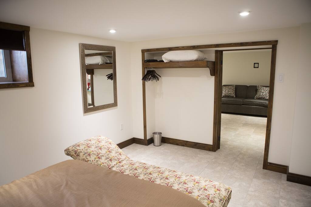 Bedroom 4 | rear basement bedroom . queen bed . chaise . tv