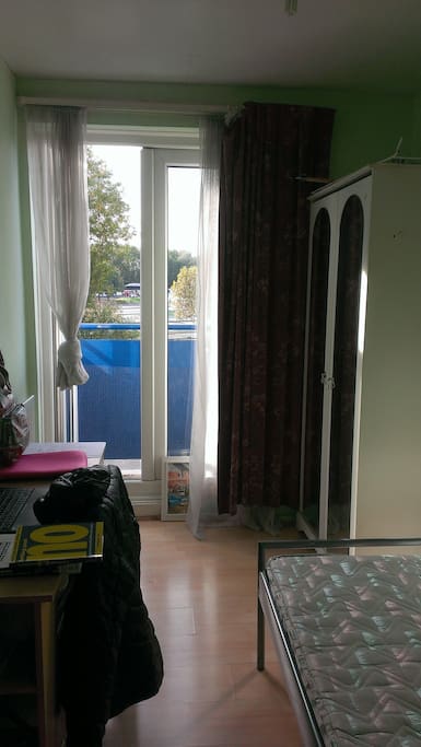 room equipped with wardrobe, desk and chair