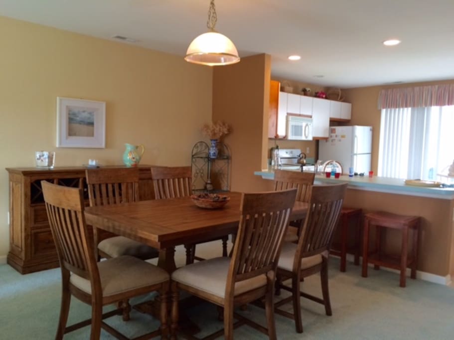 Dining room, bar, and open kitchen with deck