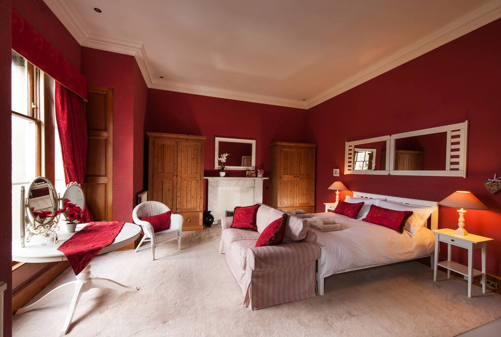 This is the main bedroom set to the front of the house with a seaview. It has a king size bed its own ensuite with a corner bath and shower.
