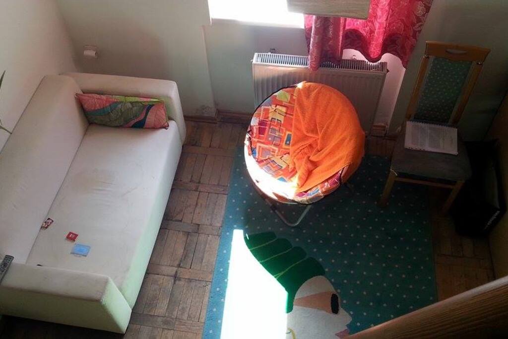 Couch no longer included, but there are chairs and a single bed.