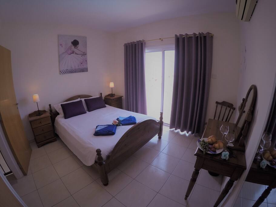 Master bedroom with a balcony overlooking the pool.