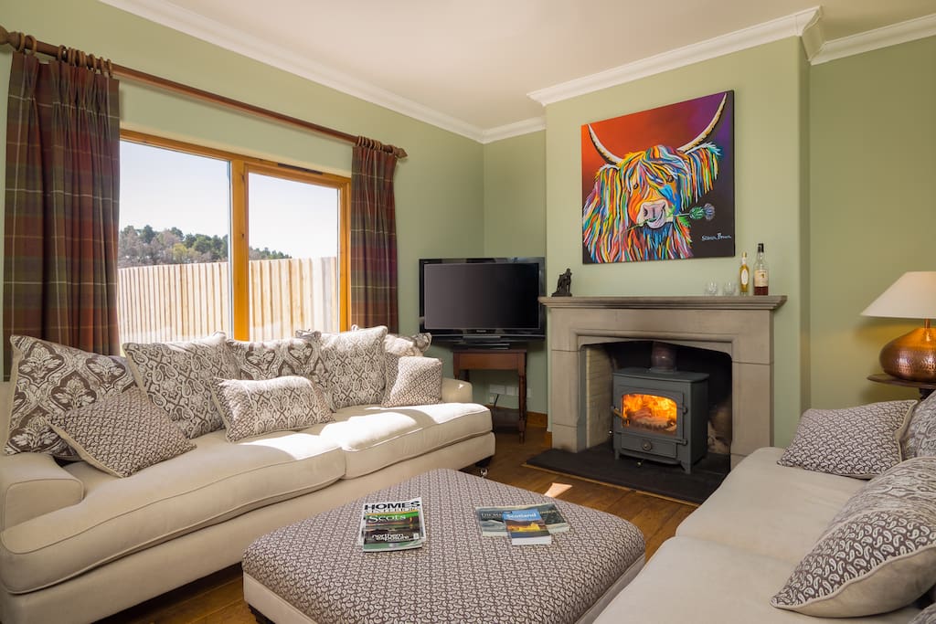 The cosy lounge with woodburner and extremely comfy sofas.