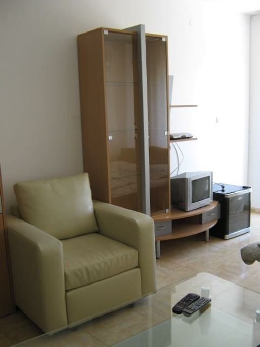 The living room with the TV (cable tv)