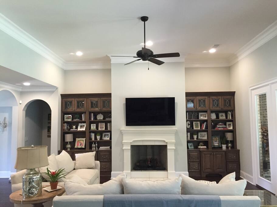 Picture of living area taken from kitchen to show that is open with vaulted ceilings.