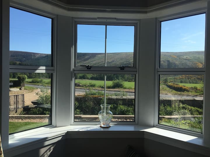 View from the from bay window to the hills on the other side of the road in the Glen of Rothes.