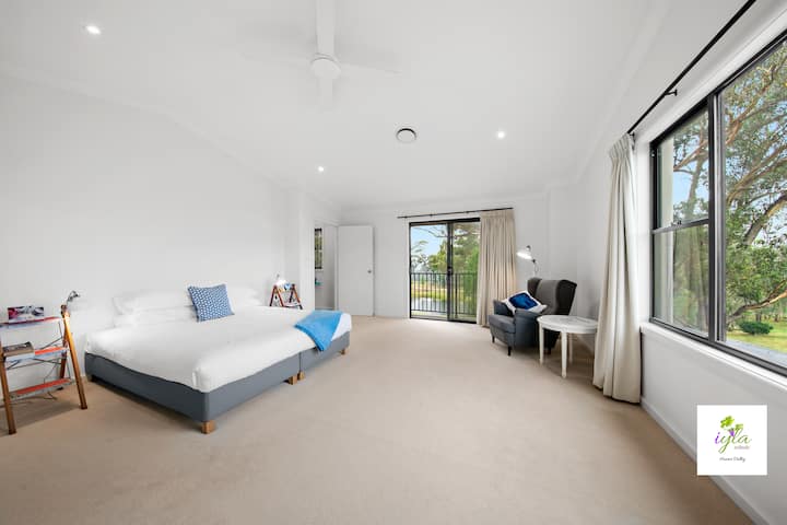 Upstairs Master Bedroom 1 with king bed, balcony, vineyard & dam views and an ensuite