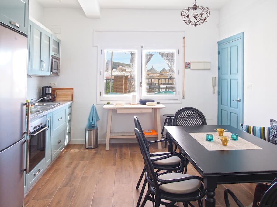Kitchen with dining area. Door on the right leads to entrance hall and terrace
