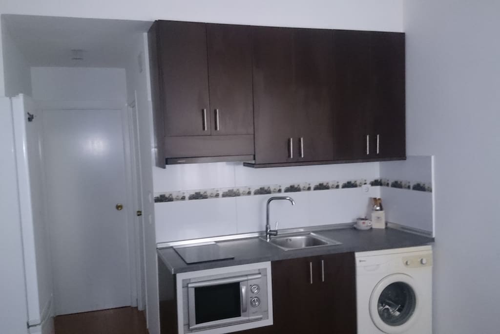 COCINA CON DOS FUEGOS, ESTRACTOR, LAVADORA, NEVERA Y MICROHONDAS.
