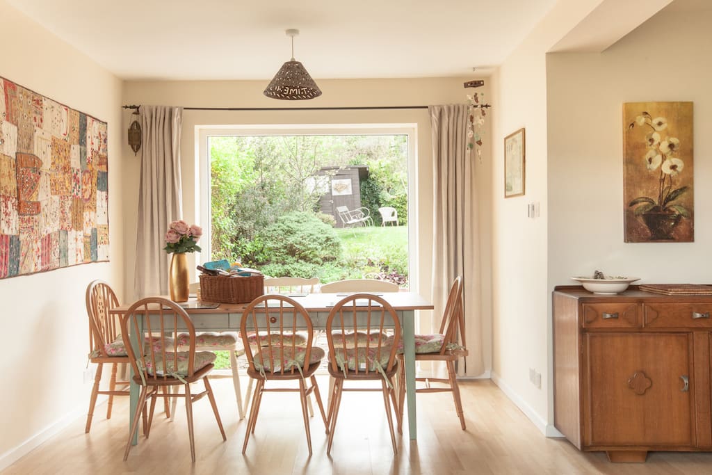 light filled dining area seats 8 with views to the back and front gardens at The Pink House Lulworth