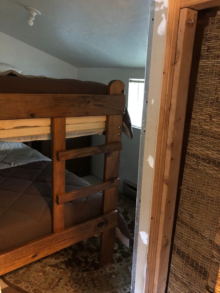 Small Bunk bed room with privacy screen door 