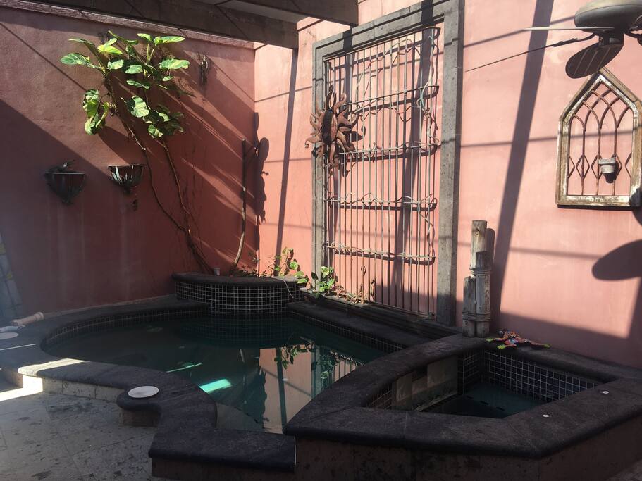 Outdoor covered pool by entryway