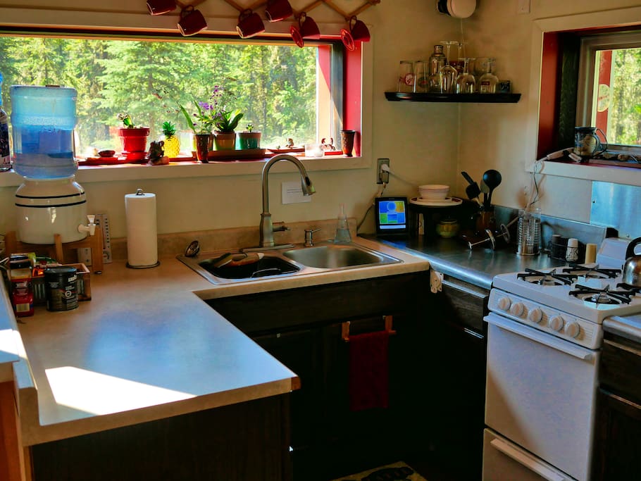 Make a simple meal or a gourmet course in this fully functional kitchen with running water, a propane stove top/oven, a small refrigerator, and basic amenities