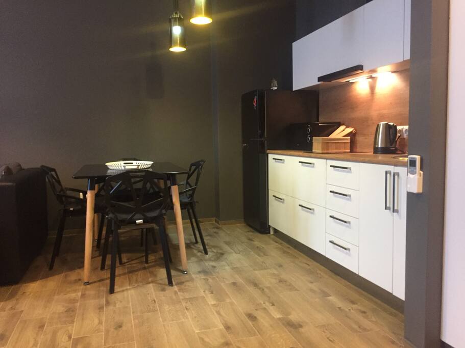 The kitchen area has a nice, large table for dining and work.