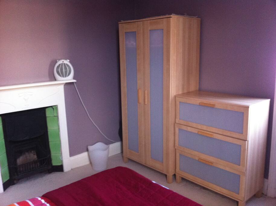 Drawers and wardrobe (open fire doesn't work but there is a radiator and electric heater in the room).