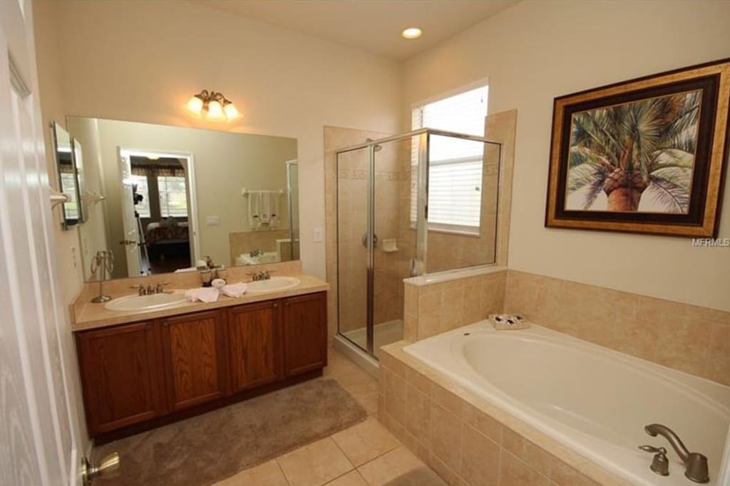 bathroom are with double sink, bath and shower