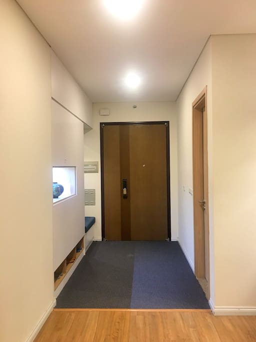 Entrance to the apartment. A big cupboard with a mirror is used to stock slippers, extra toilet papers, extra towels