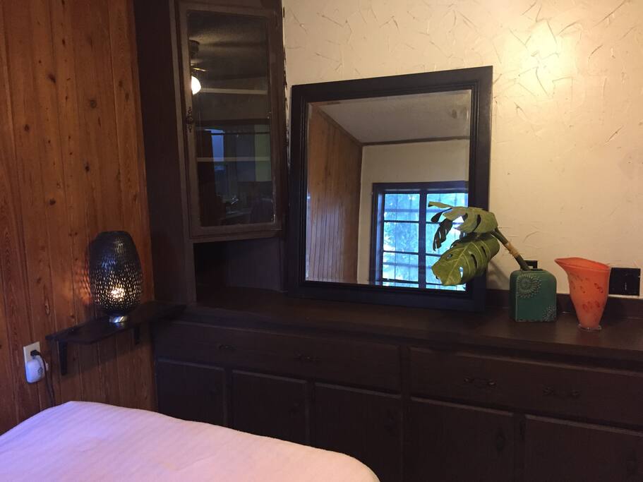 Desk with dresser drawers, shelves, mirror, and bedside lamp