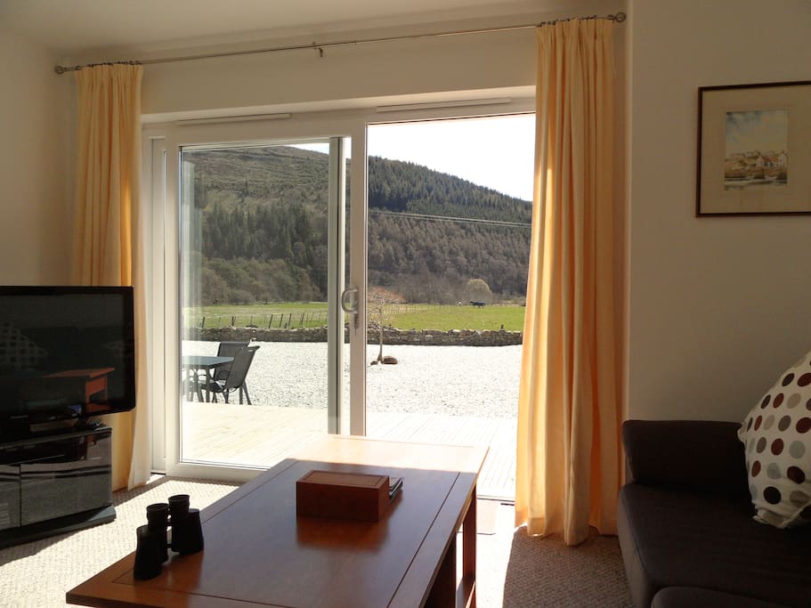 Lounge with patio doors and level access to deck